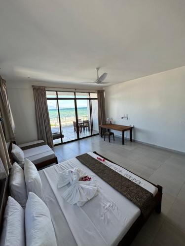 a living room with a large bed and a table at YU Resort in Msambweni