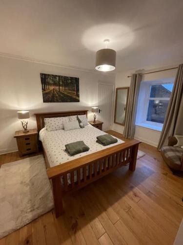 a bedroom with a large bed in a room at Daisy Cottagee in Alyth