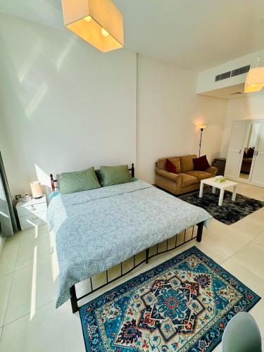 a bedroom with a large bed and a rug at Luxurious Room with Dedicated Bathroom Near Rigga Metro with all Modern Facilities in Dubai