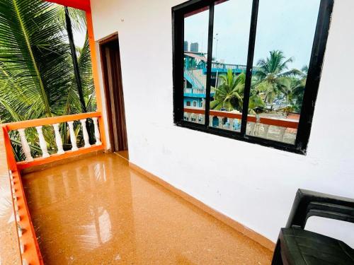 a room with a window and a view of the ocean at La Pescador Home Stay, Baga in Baga