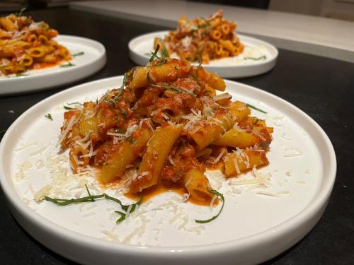 a plate of food with pasta on a table at Sans Souci Bed and Breakfast Luxe Heated Pool and Restaurant in Luzillé