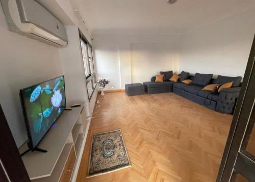 a living room with a couch and a flat screen tv at Cairo modern apartment in Cairo
