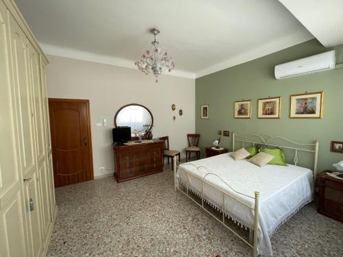 a bedroom with a bed and a television in it at Dimora Cadò Alloggio Turistico Privato in Taranto