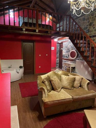 a living room with a couch and a staircase at Gioras Hotel in Palaios Agios Athanasios