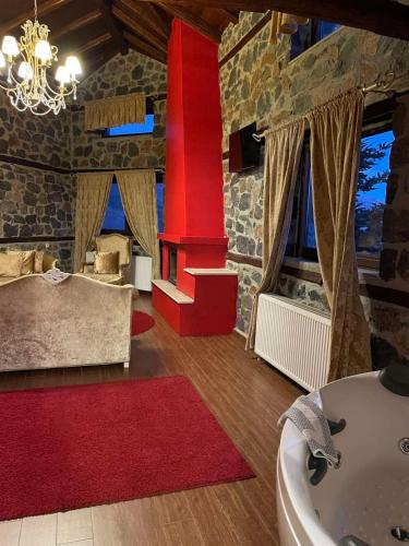 a bathroom with a red column and a sink at Gioras Hotel in Palaios Agios Athanasios