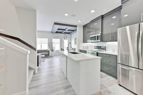 a kitchen with white appliances and a white counter top at Sunny Perch Stay in Edmonton