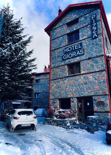 a car parked in front of a hotel clangers at Gioras Hotel in Palaios Agios Athanasios