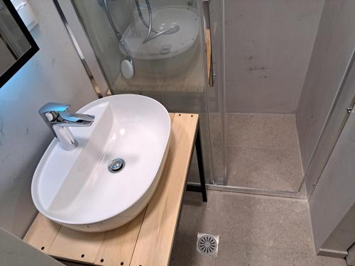 a bathroom with a white sink and a shower at SOCRATES Ethnic and traditional STUDIO in Kalabaka