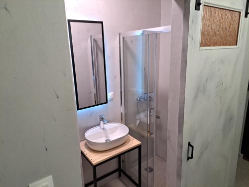a bathroom with a sink and a shower at SOCRATES Ethnic and traditional STUDIO in Kalabaka
