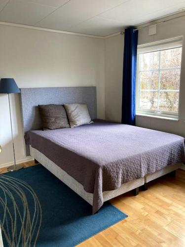 a bedroom with a bed in a room with a window at Ronningen Villa in Strömstad
