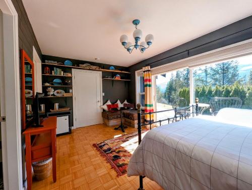 a bedroom with a bed and a large window at Gurus Of Gravel Bike Retreat Guest Suite in Clearwater