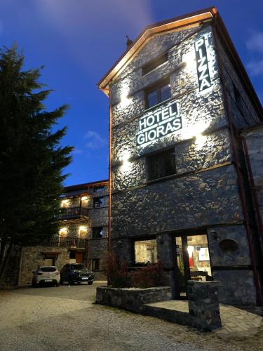a hotel sign on the side of a building at Gioras Hotel in Palaios Agios Athanasios
