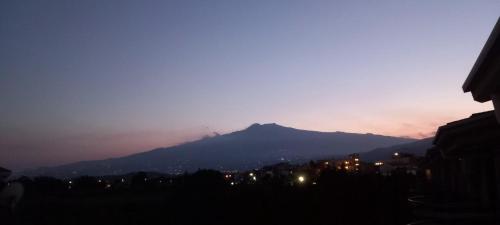 a view of a mountain at night with a city at Bluesky Apartment Naxos 3rd floor in Giardini Naxos