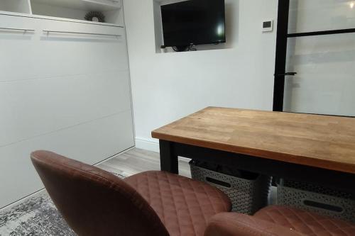 a dining room with a wooden table and two chairs at The Nook: Self Contained Annex in Taunton