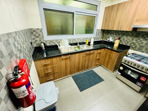 a kitchen with a fire hydrant in the middle of it at Modern Room With Attached Bathroom Near Rigga Metro & Close to Airport in Dubai