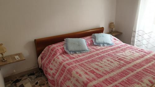 a bedroom with a bed with two pillows on it at Bingo 1 completo in Alghero