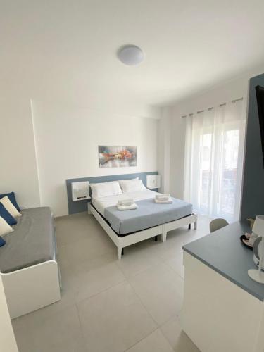 a white room with a bed and a couch at Seaway Accommodation " Private Parking " in Tropea