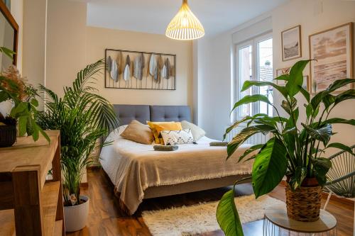 a bedroom with a bed with plants in it at Appartement Standing piscine intérieur privatisée . in Mutzig