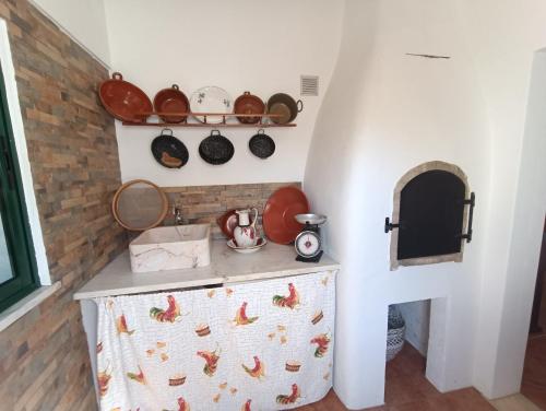 a kitchen with a counter with pots and pans at Casa dos avós in São Brás de Alportel