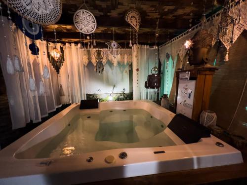 a large bath tub in a room with chandeliers at Casa de Veraneio Villa Lopes in Bonfim