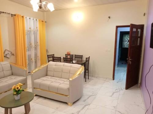 a living room with two couches and a table at RESIDENCE WALNICK in Douala