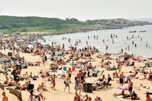 a large crowd of people on a beach at House by the ocean in Halmstad