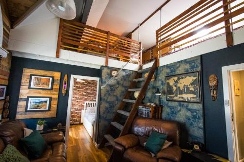 a living room with a loft bed and a staircase at 2 Independant Boutique Apartments one sleeps 2 the other sleeps 4, Meadowhall, Sheffield Arena, Free Parking in Sheffield