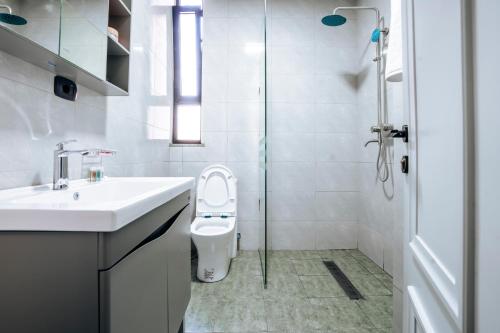 a bathroom with a toilet and a sink and a shower at Amnen Apartments in Addis Ababa