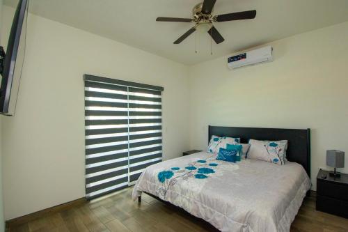 a bedroom with a bed and a ceiling fan at Residence 35 in Puerto Peñasco