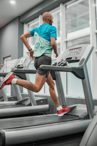 a man running on a treadmill in a gym at Luxury condos on 18th, 5th and 3rd floor, with pool, fitness, parking included in Skopje