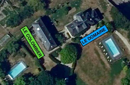 an aerial view of a house with a sign that reads us zoning at Les gîtes du Champ-De-Bataille in Sainte-Opportune-du-Bosc
