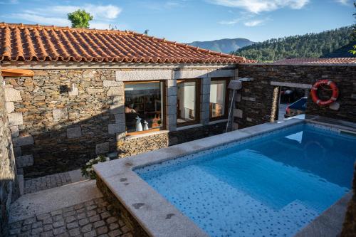 a house with a swimming pool next to a building at Casa da Ferreira_Vila Real in Vila Real