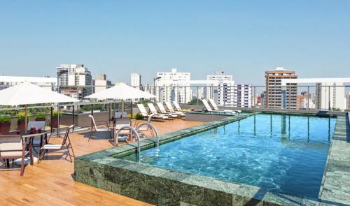 a swimming pool on the roof of a building at Studio Alto Padrão Brooklin in Sao Paulo