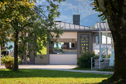 a house in a park with a tree at Apollo AchtQuartier Das Hotel am Mondsee in Mondsee