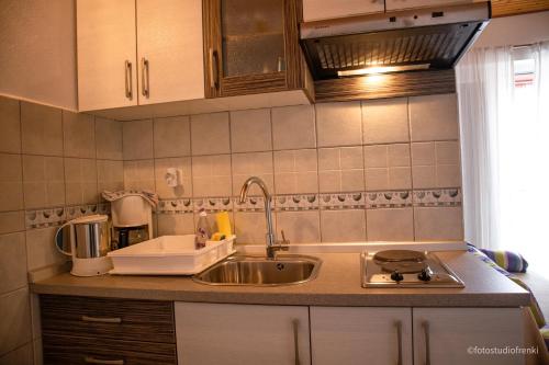 a kitchen with a sink and a counter top at Guesthouse Marija II in Lopar