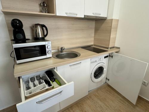 a small kitchen with a sink and a microwave at HORIZON 12 'A' APARTMENT Sveti Vlas in Sveti Vlas