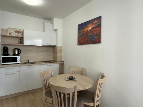 a small kitchen with a table and chairs in a room at HORIZON 12 'A' APARTMENT Sveti Vlas in Sveti Vlas