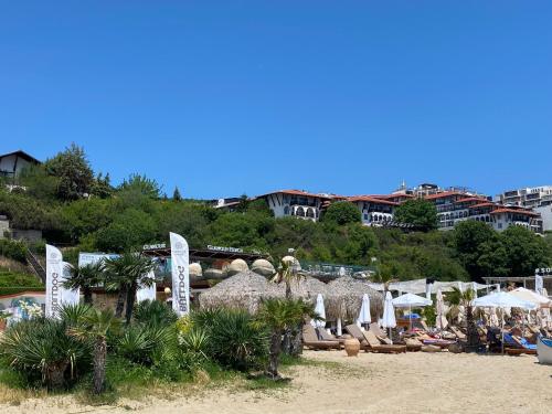 a beach with a bunch of umbrellas and chairs at HORIZON 12 'A' APARTMENT Sveti Vlas in Sveti Vlas