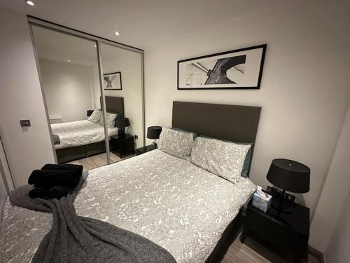 a bedroom with a bed and a mirror at Modern Flat in Camden Town in London