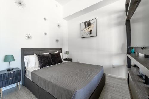 a bedroom with a bed and a flat screen tv at TR Miami 2 Bedroom, 1 Bedroom, and Studio Condos with Balconies in Miami