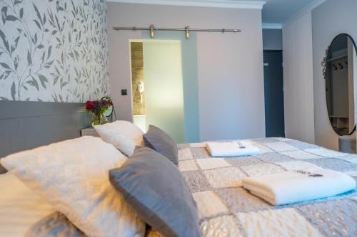 a bedroom with a bed with two pillows on it at Apartamenty Admirał  in Solina