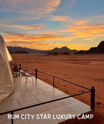 a tent with a table and chairs in the desert at Rum city Star LUXURY Camp in Wadi Rum