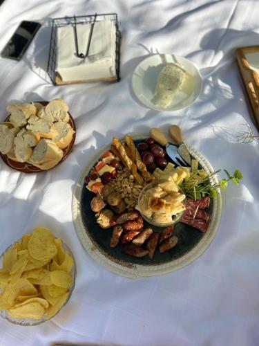 a table topped with a plate of food and snacks at Casa Campo ao Rio_Village in Barcelos