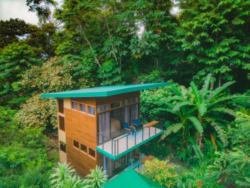 a tree house with two chairs on a balcony at Arenal Getaway in Fortuna