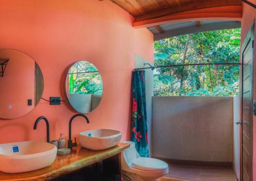 a bathroom with two sinks and a shower at Arenal Getaway in Fortuna