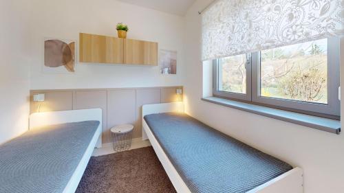 a room with two beds and a window at Na Domečku Valtice in Valtice