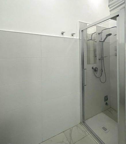 a bathroom with a shower with a glass door at Stile Libero Guest House in Turin
