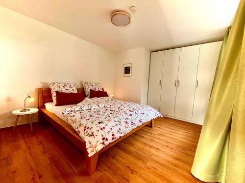 a bedroom with a bed and a wooden floor at Ferienwohnung Hahn in Reifferscheid