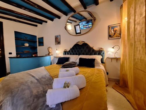 a bedroom with a large bed with towels on it at Ωlimpiα Apartment in Rome