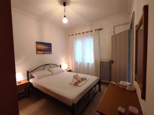 a small bedroom with a bed and a window at Corfu Pintsis House 2 in Kompítsion